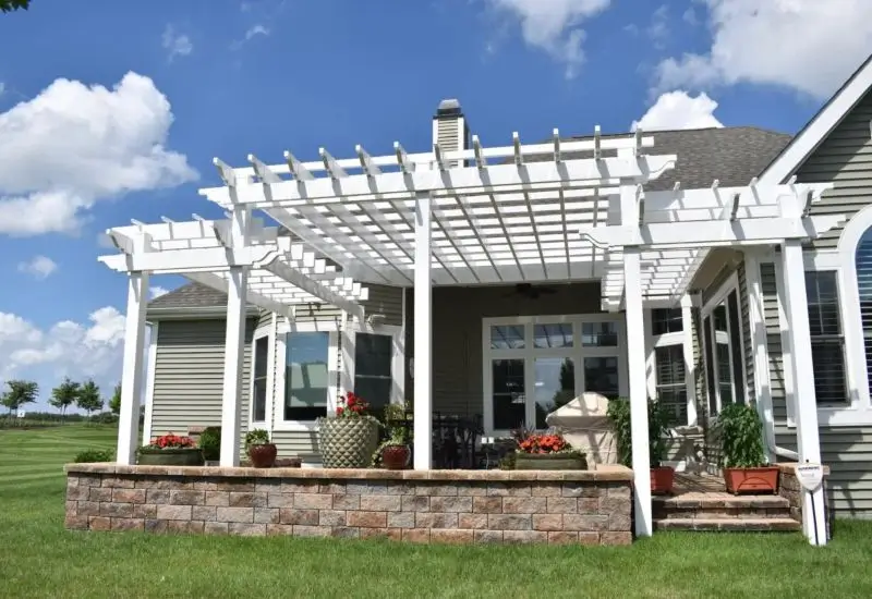 White pergola attached to the house